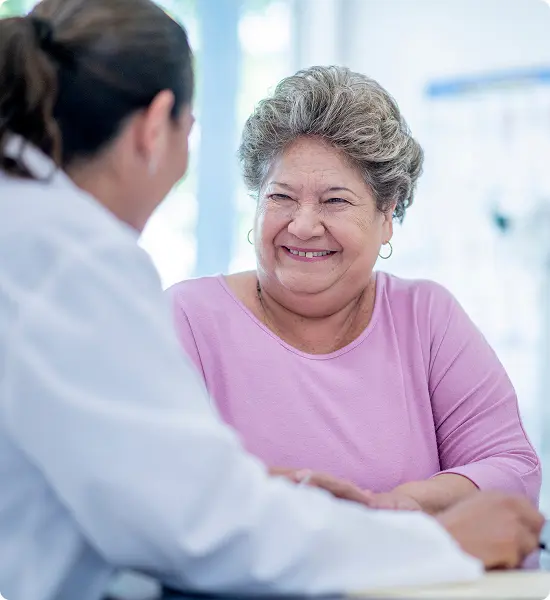 A female patient smiles at her practitioner